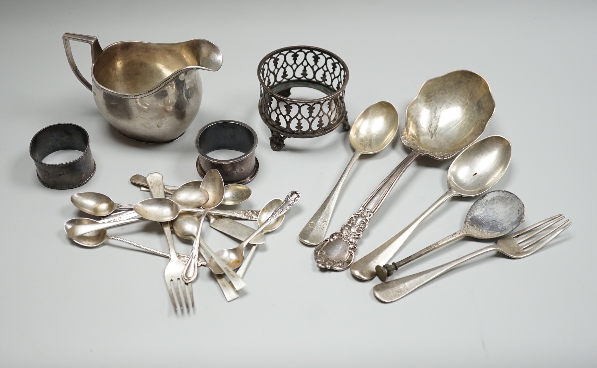 Sundry small silver including a 1930's cream jug, a Victorian mustard pot (no liner), two napkin rings and a small quantity of assorted silver and sterling flatware, 20.8oz.